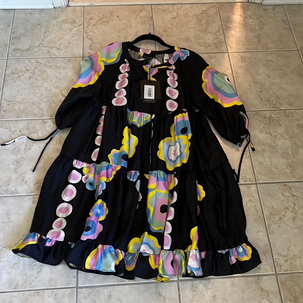 Black with pastel color flowers 3/4 length sleeve hits the knees on 5”5